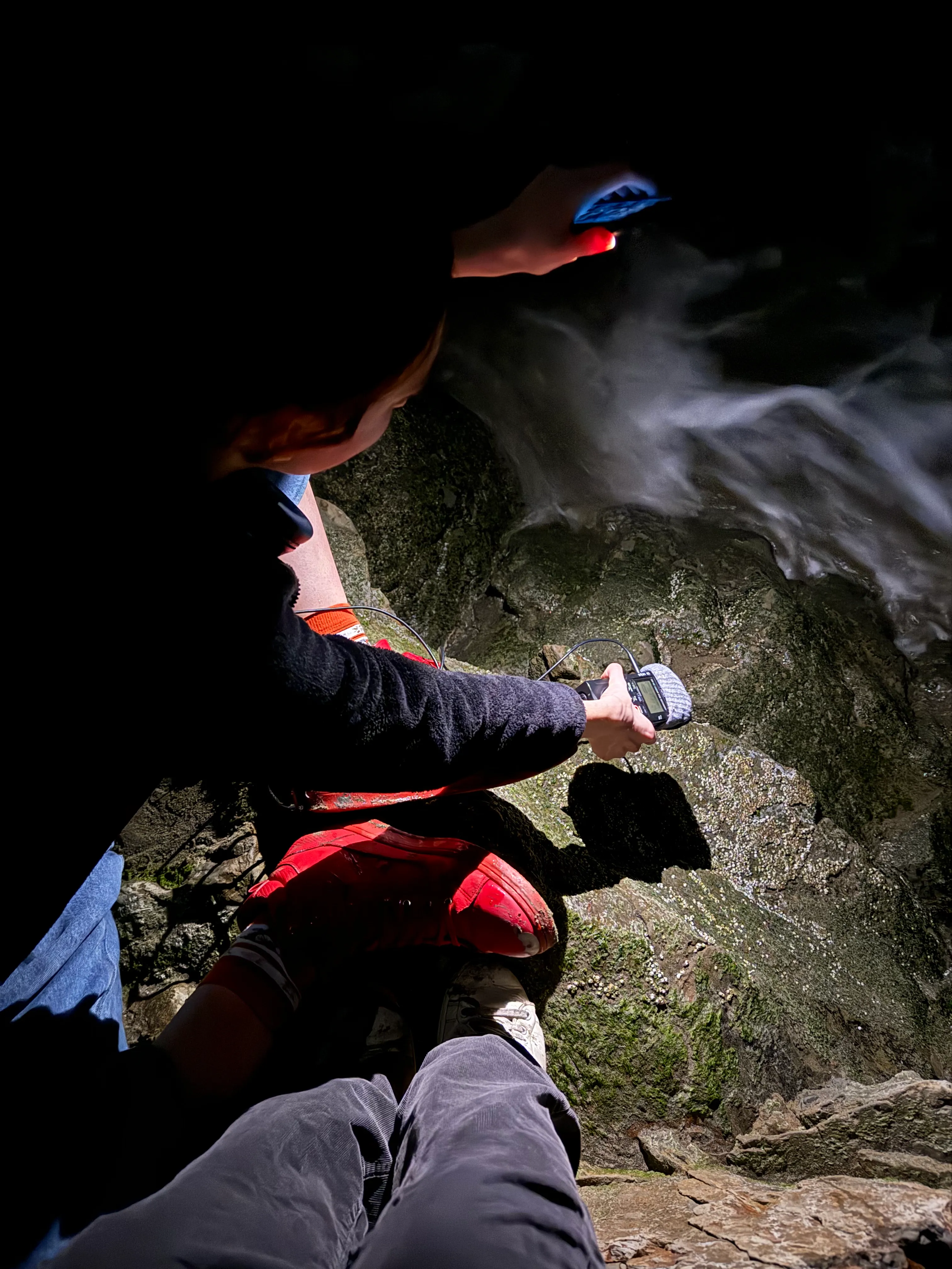 At the ocean, field recorder in hand close to waves.